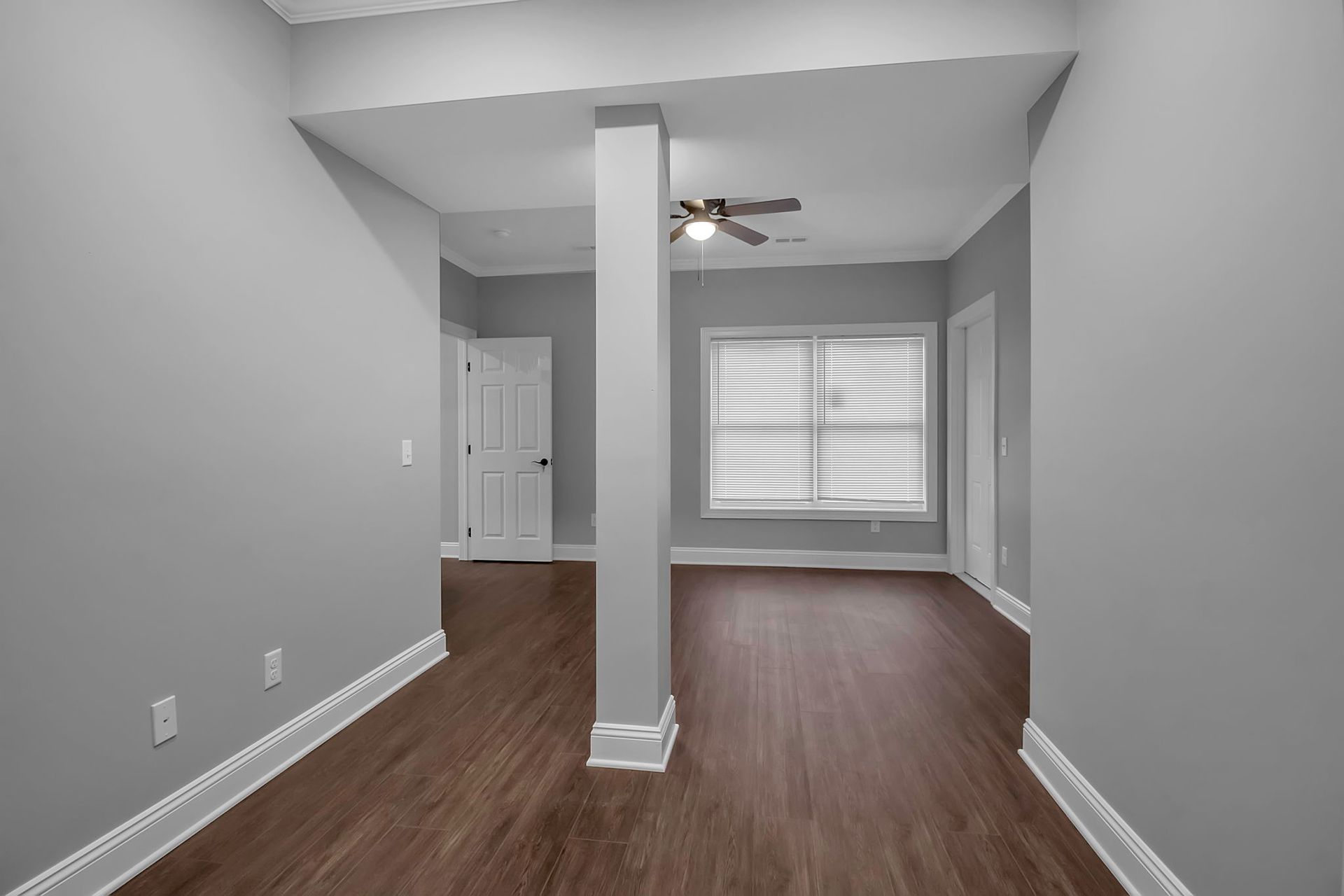 Open living area with wide windows overlooking neighborhood