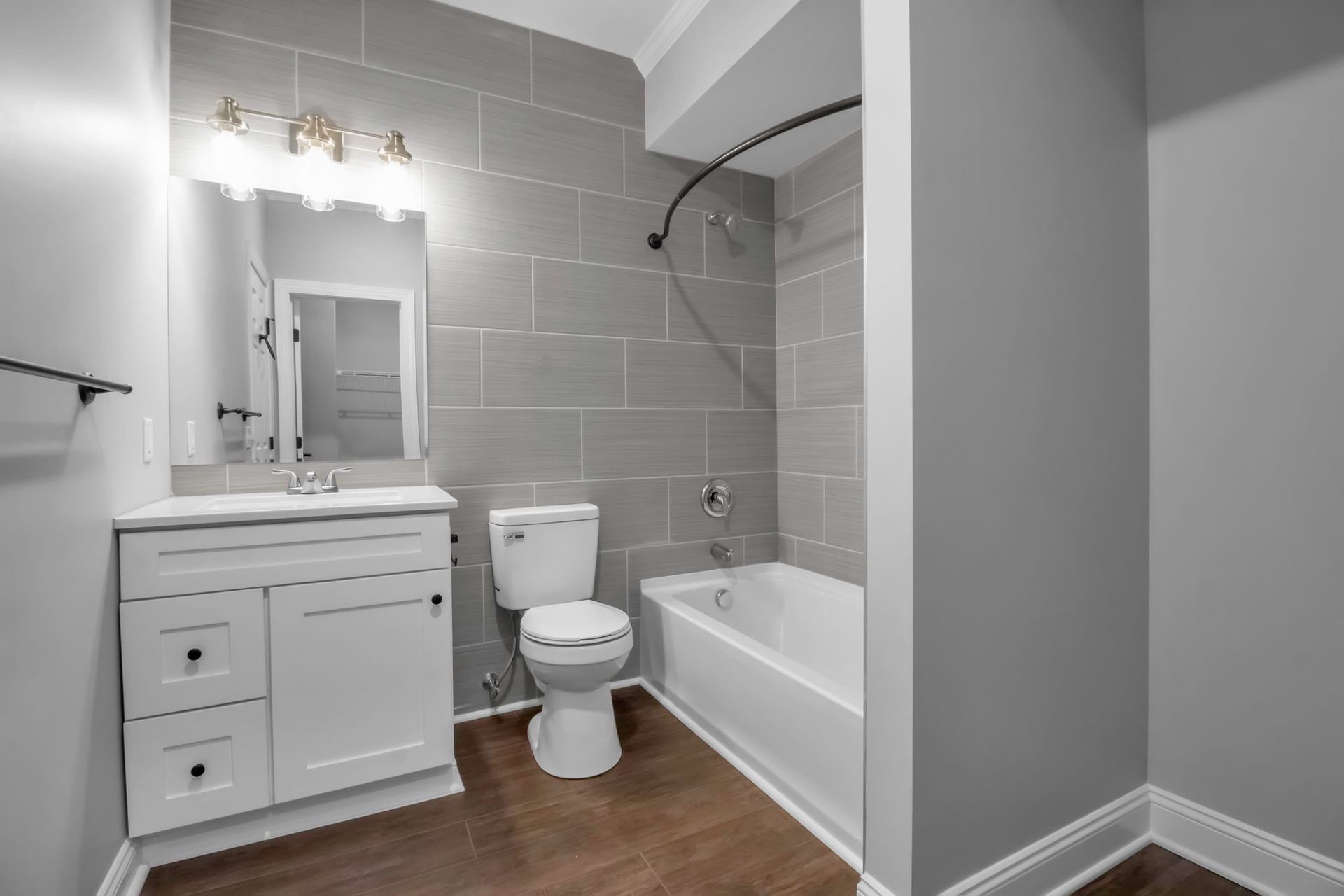 Modern apartment bathroom with vanity sink and mirror lighting