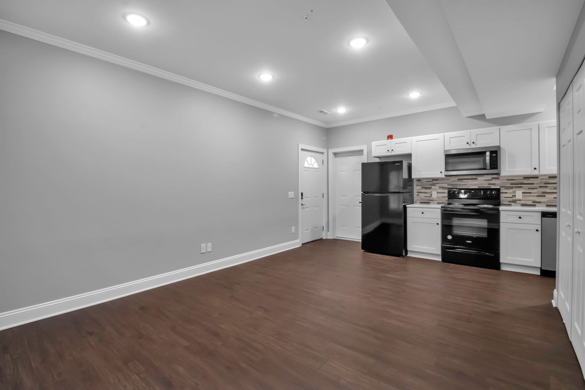 Apartment kitchen interior featuring sleek cabinetry design