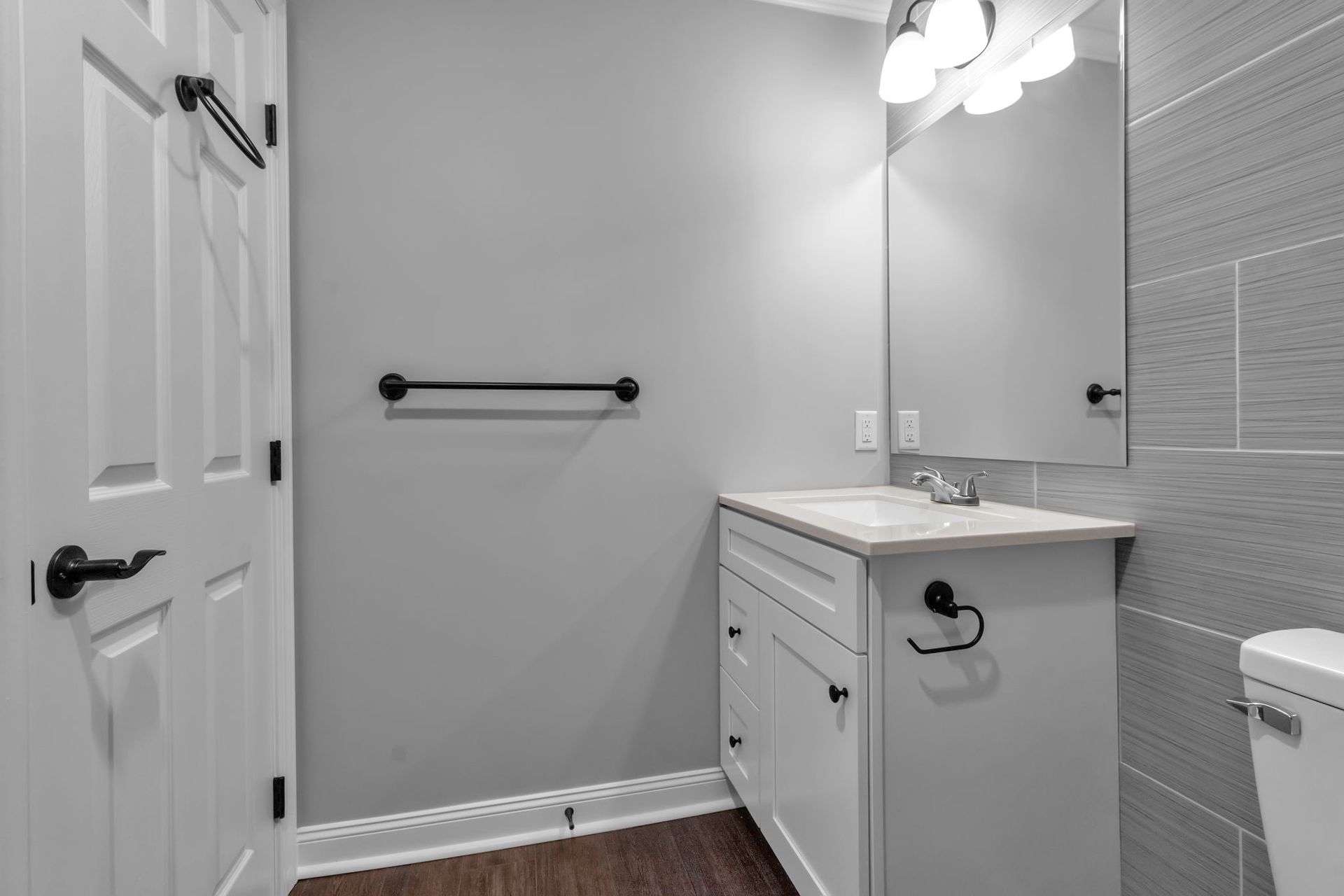 Bathroom area with updated tile surfaces and sink unit