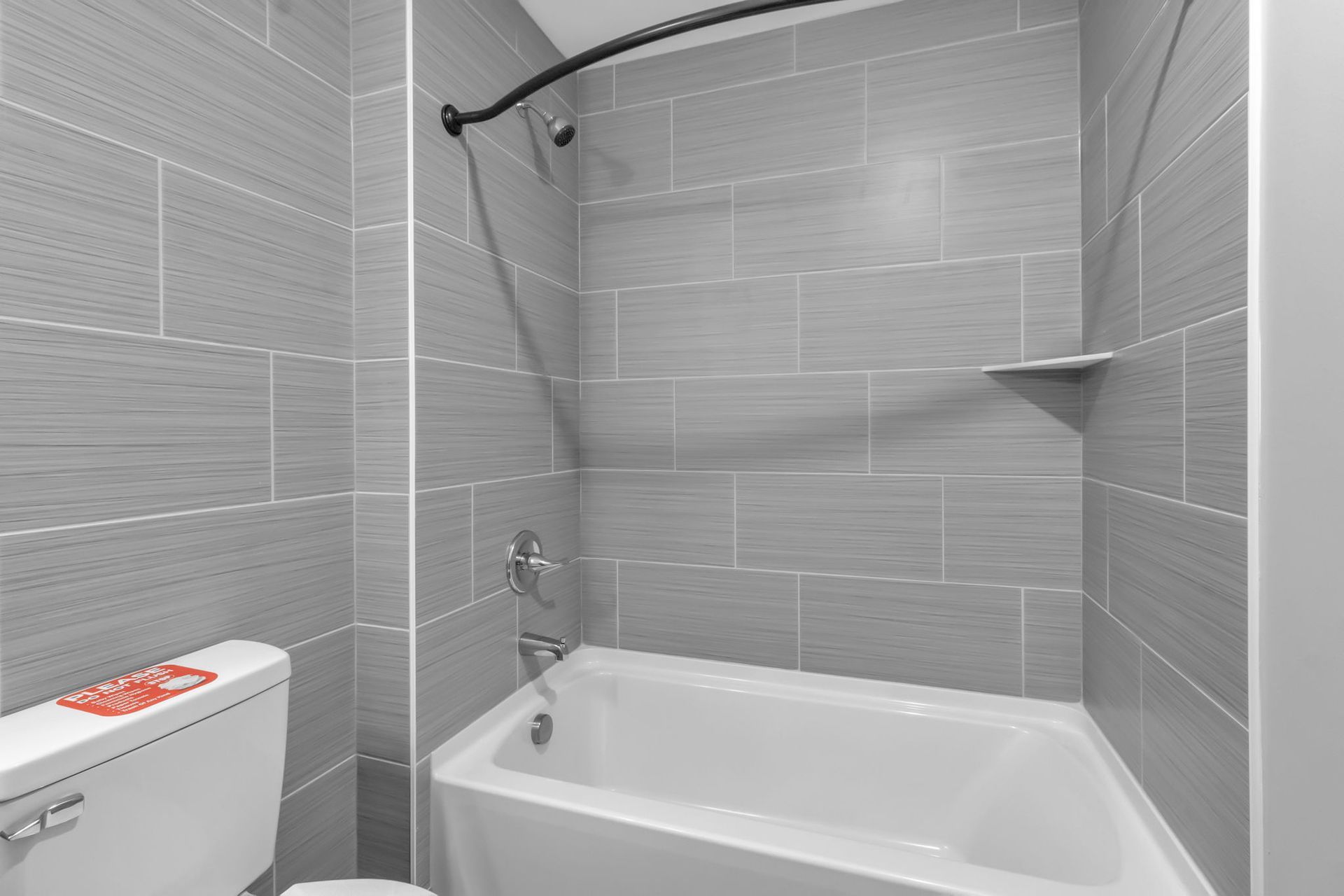 Washroom space with polished sink fixture and mirror
