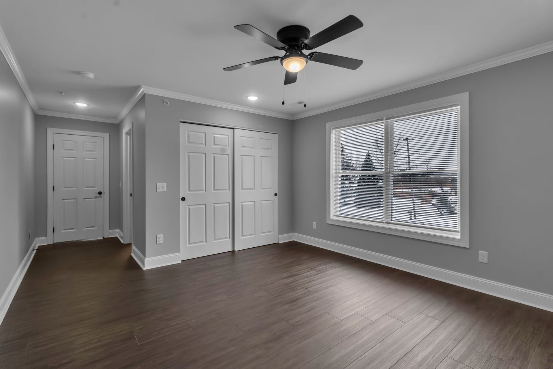 Large bedroom with open floor space and modern trim