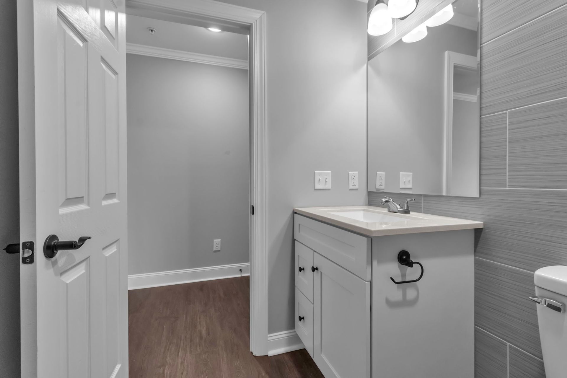 Bathroom interior featuring sleek tile and mirror design