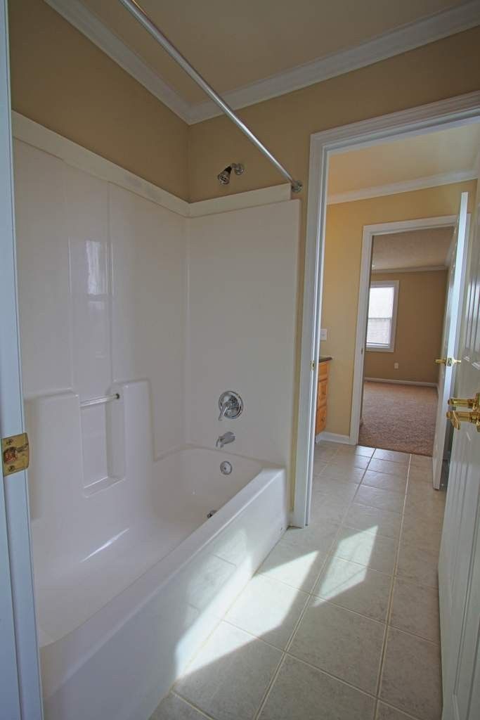 A bathroom with a bathtub and a shower.