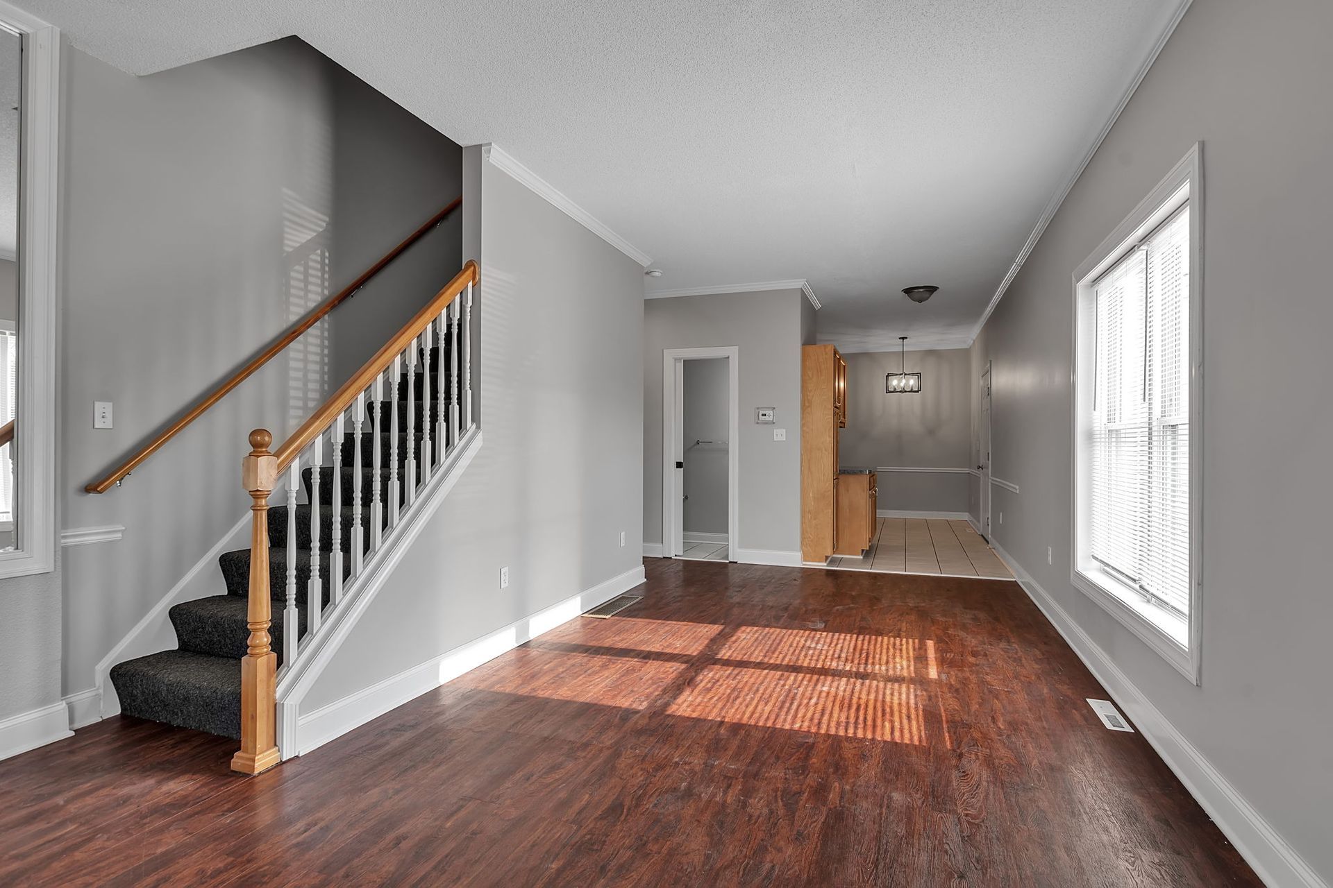 Comfortable living space with wood flooring and neutral tones