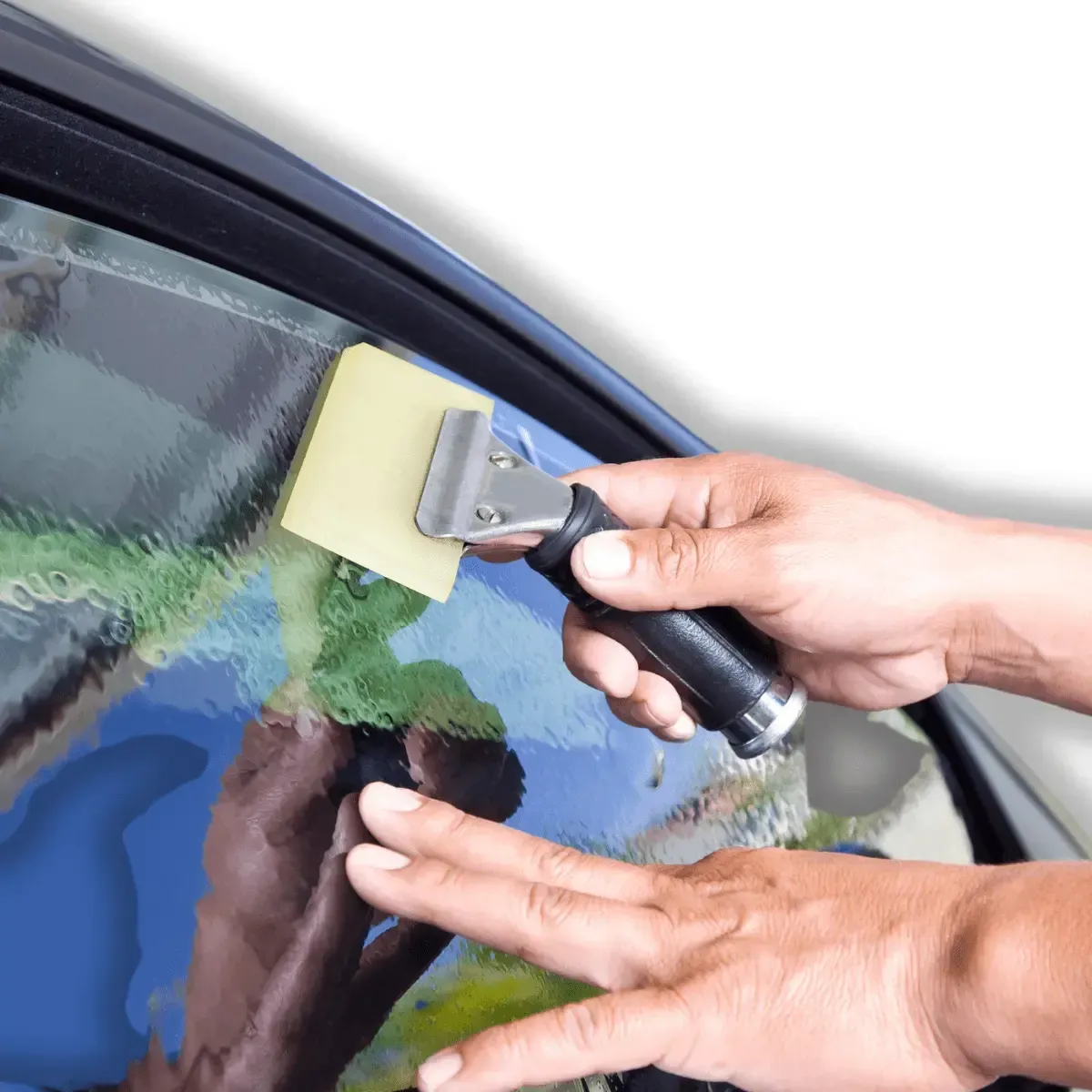 a person is cleaning a car windshield with a scraper