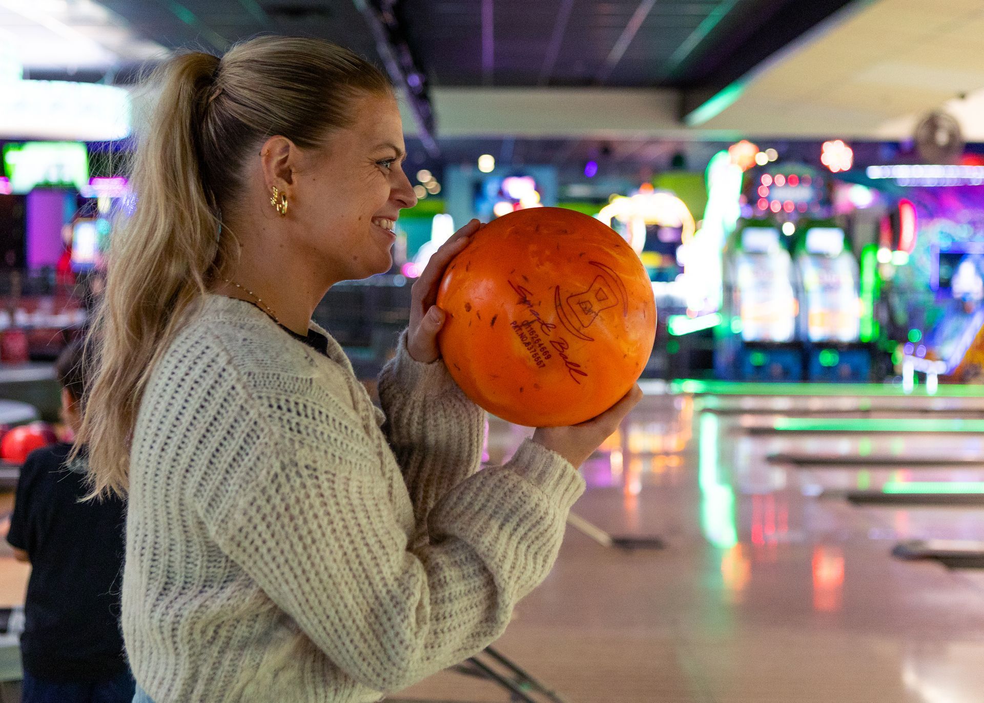 Woman bowling at Zone 28 Strike 28 group package
