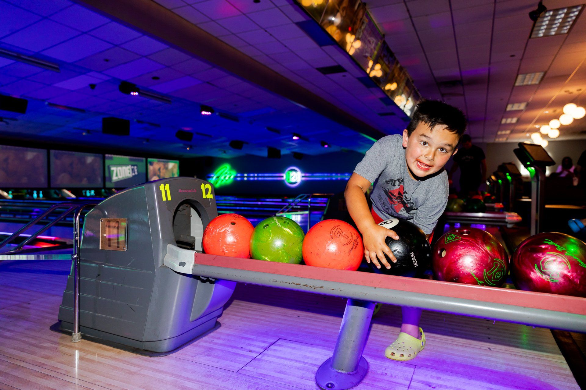 Kids bowling birthday party at Zone 28 in Pittsburgh with glow-in-the-dark lanes