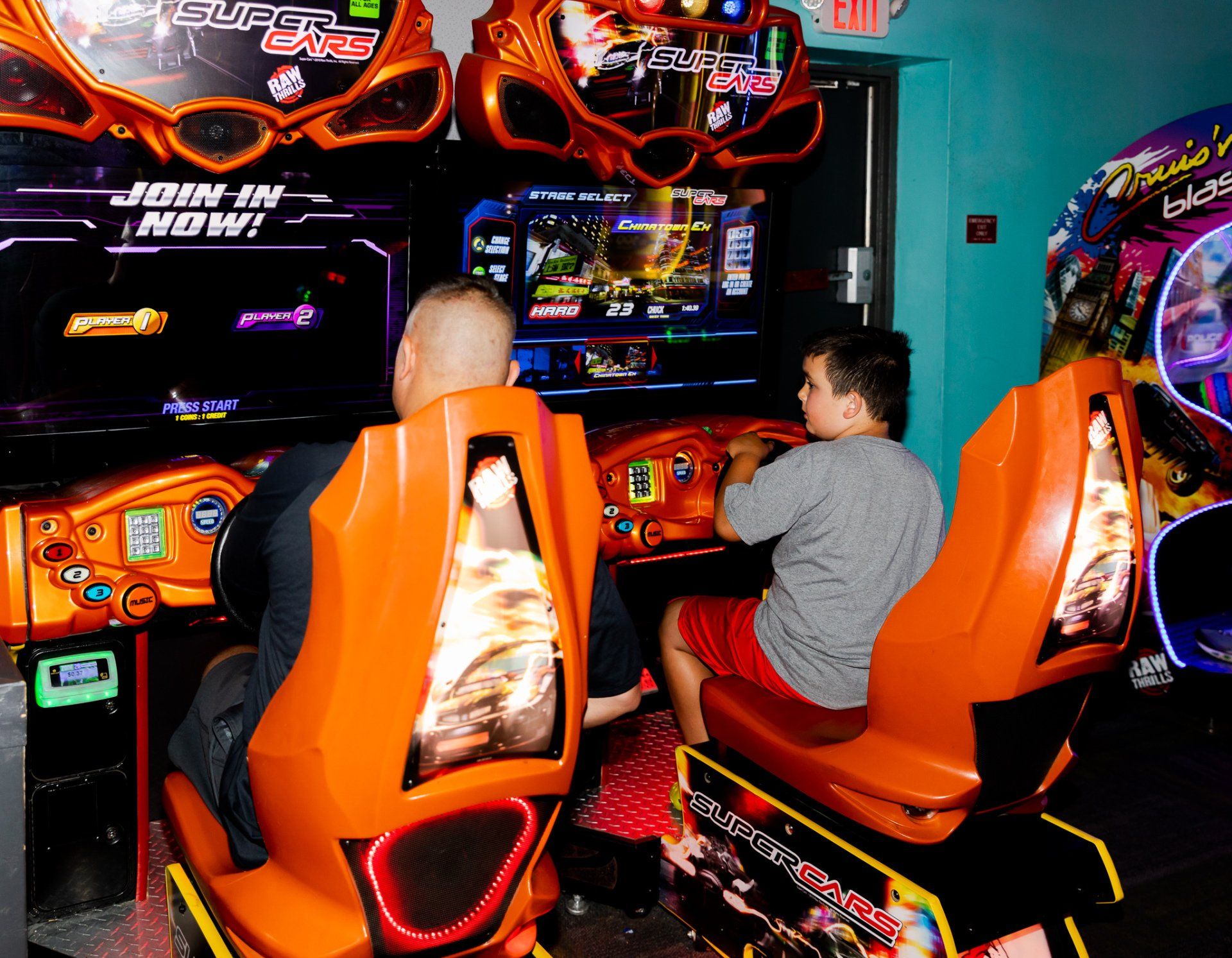 Kids playing arcade racing games at a Super Zone birthday party at Zone 28 Pittsburgh