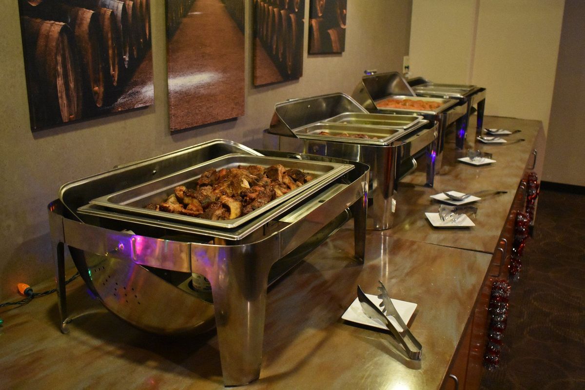 A hot buffet in chafing dishes set up for a holiday party in Suite 28 at Zone 28 in Pittsburgh