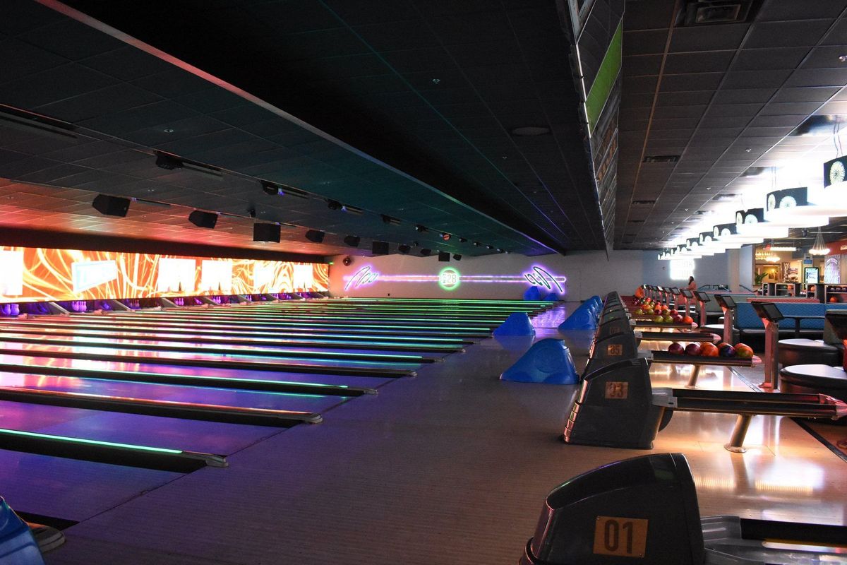 The glow bowling lanes at Zone 28 in Pittsburgh, shot down the line of lanes under black light