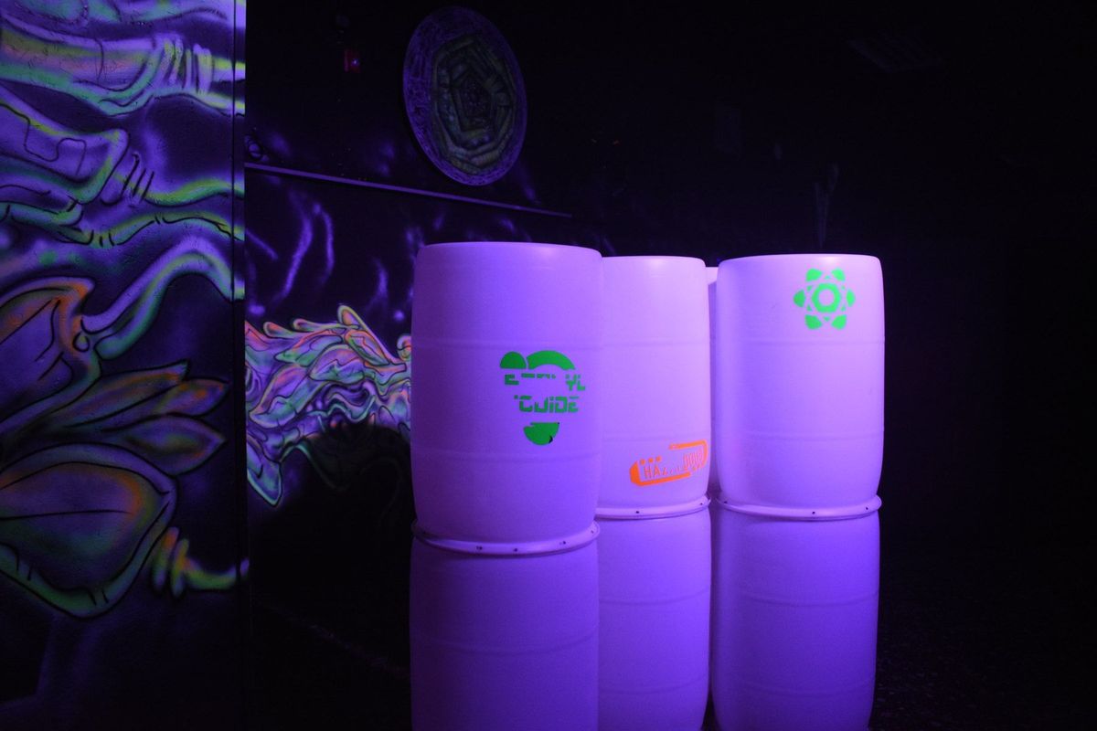 Glowing barrels used as cover inside the blacklit Area 28 laser tag arena at Zone 28 in Pittsburgh