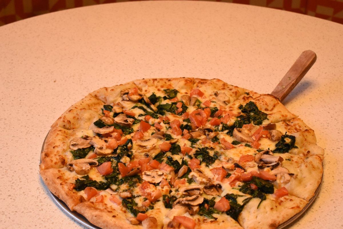 A fresh-baked spinach, mushroom and tomato pizza at Zone 28 in Pittsburgh