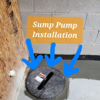 Sump pump installation sign above a black floor access cover with blue arrows pointing down