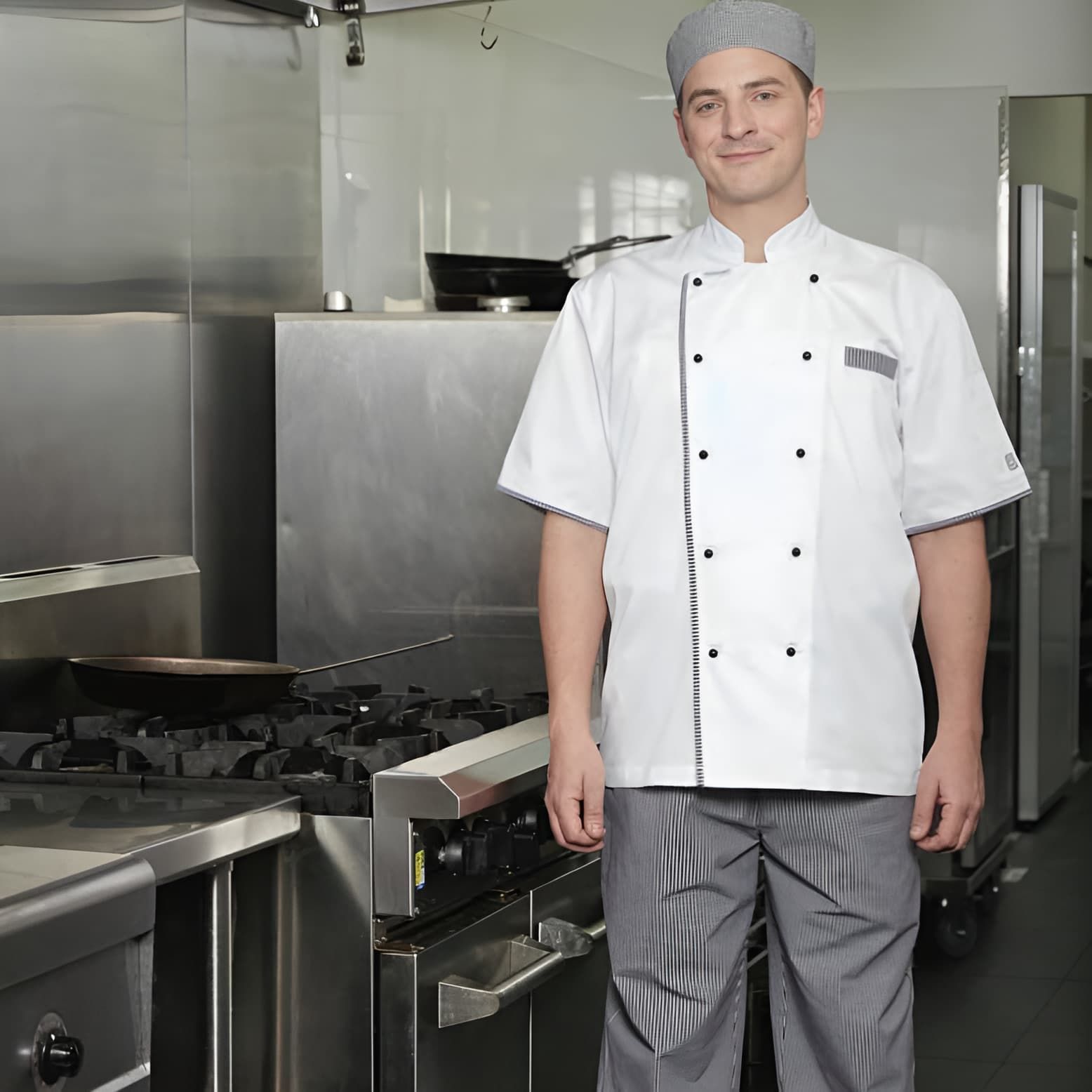A Man In A Chef 's Uniform Is Standing In A Kitchen — Caba's Drapery In Woolgoolga, NSW