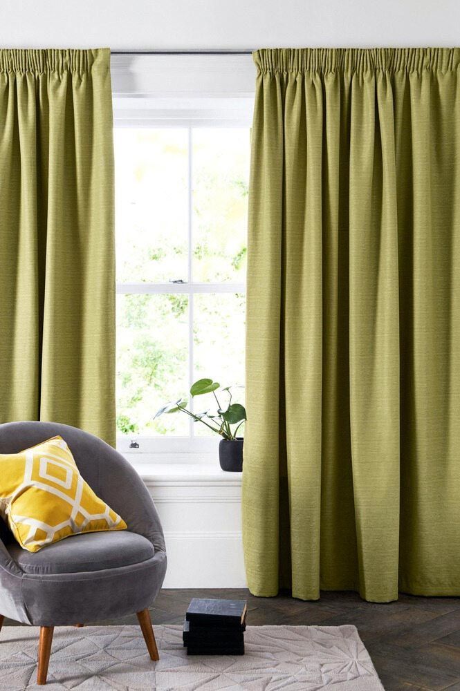 A Living Room With Green Curtains, A Chair, And A Window — Caba's Drapery In Coffs Harbour, NSW