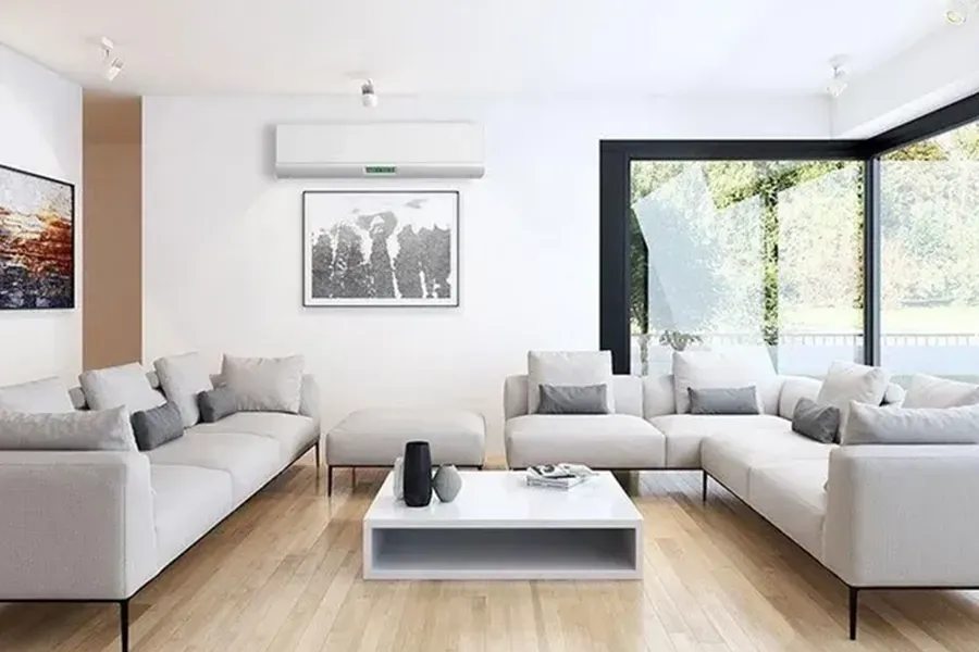 Bright modern living room with light gray sofas, coffee table, wall art, and large black-framed windows