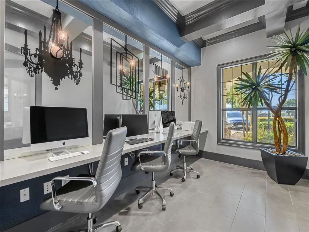 Business center with computers and office chairs.