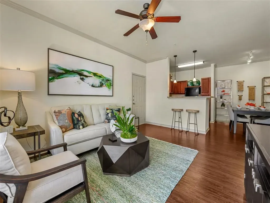 Living room with sofa, coffee table, and dining area.