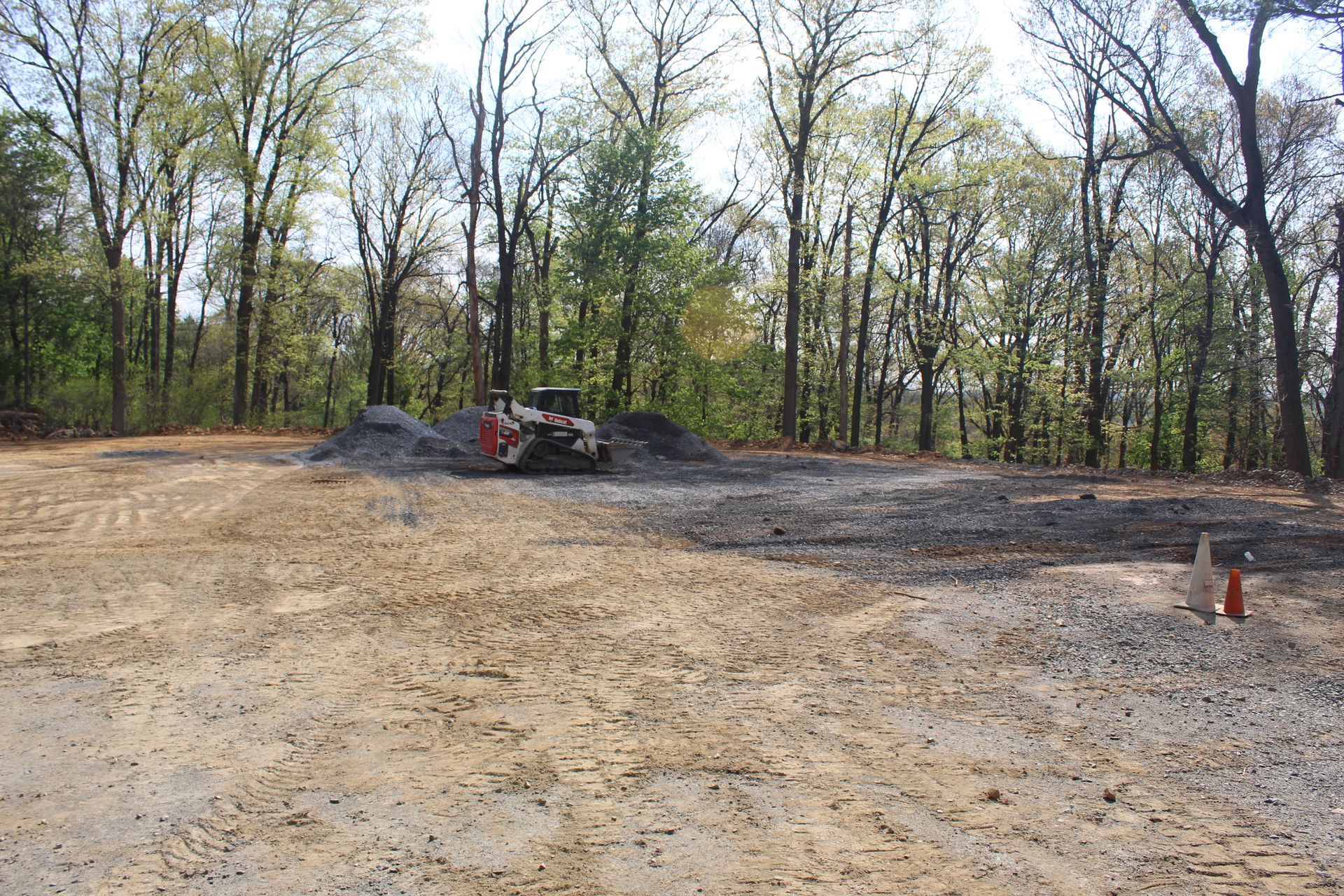 Spreading out the base layer of stone.