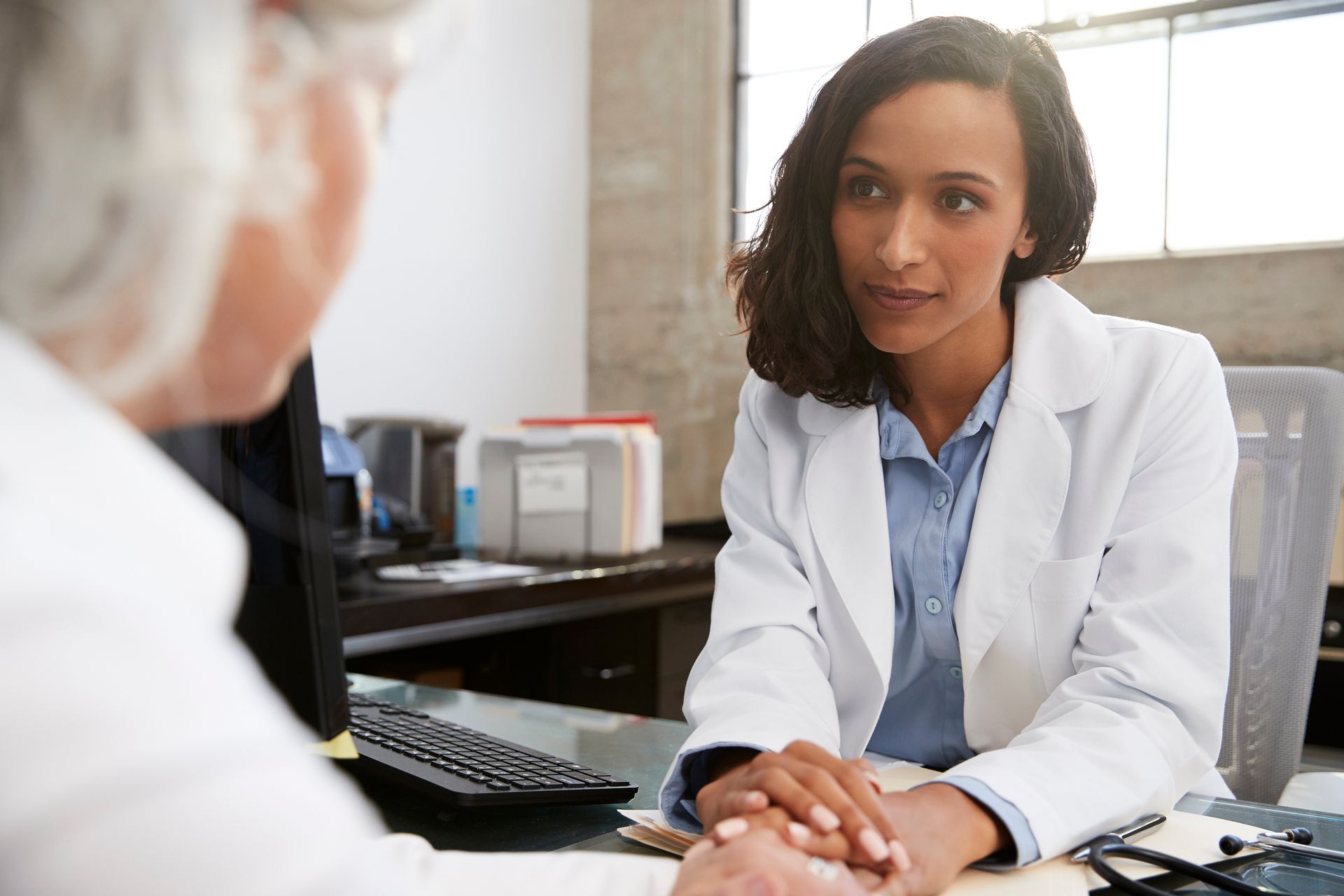 A young female psychiatrist in a consultation with a senior patient A young female psychiatrist in a consultation with a senior patient