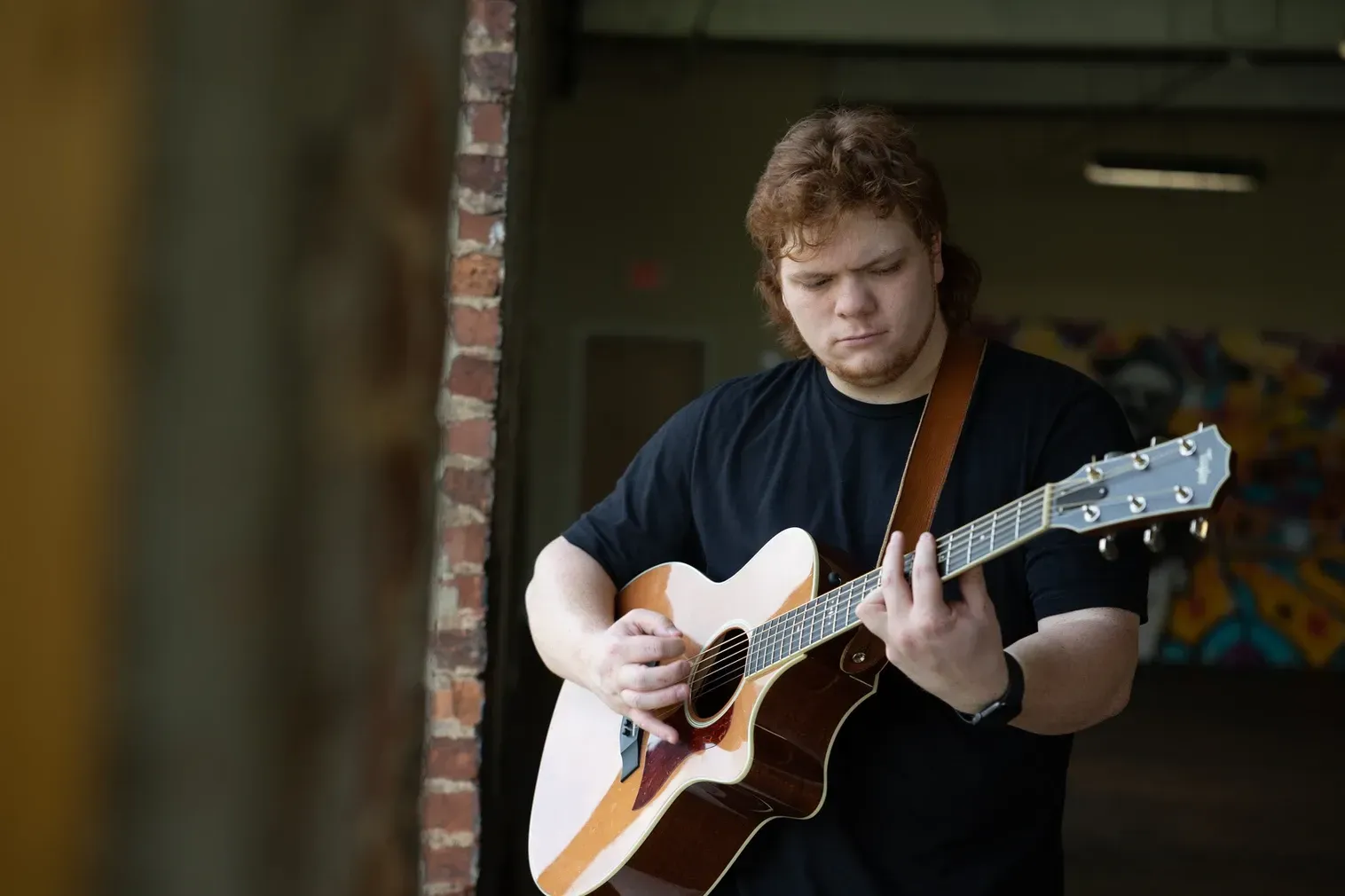 Jackson Cannon playing acoustic guitar