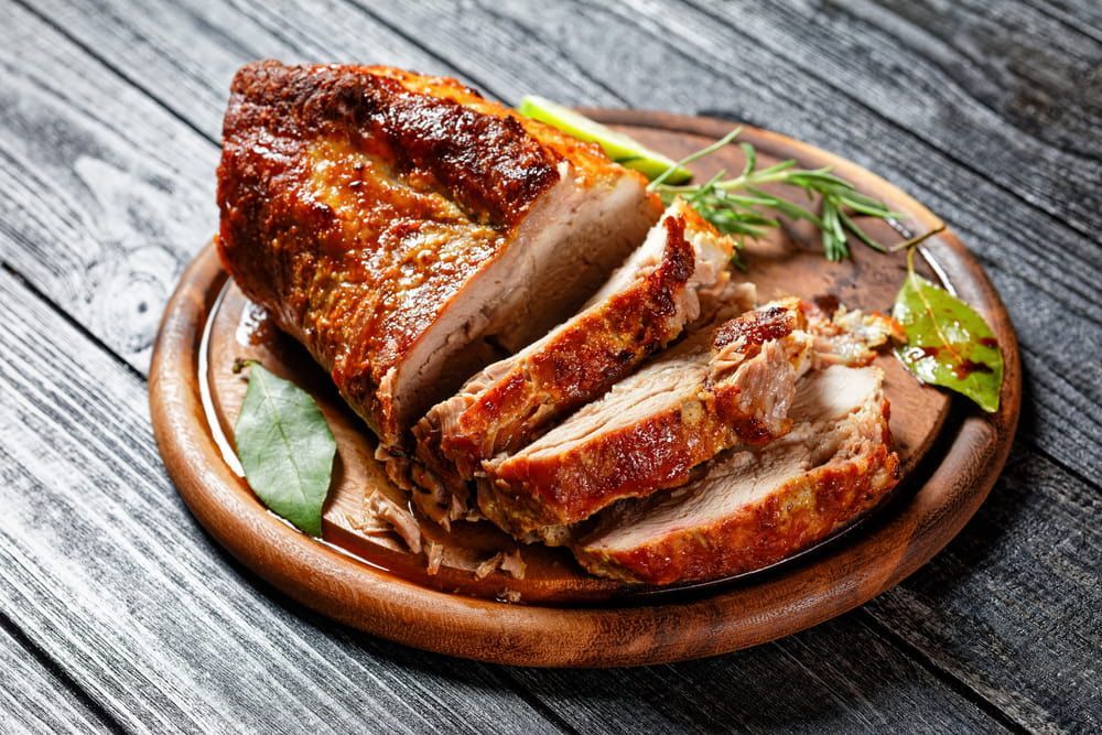 A Piece Of Meat Is On A Wooden Plate — Wattle Butchery In Cootamundra, NSW