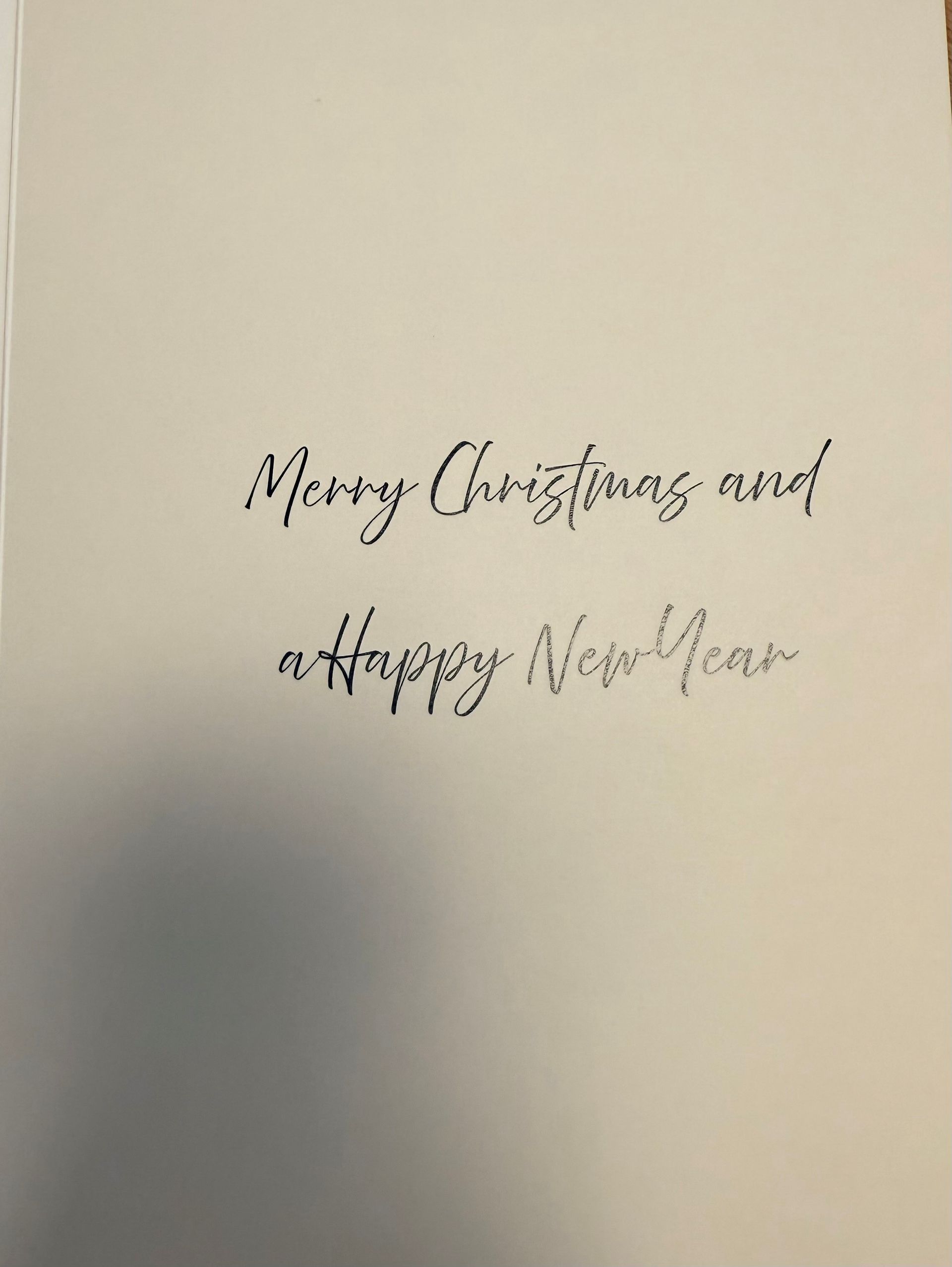 Handmade Christmas card with blue and yellow ornaments and “Merry Christmas!” text