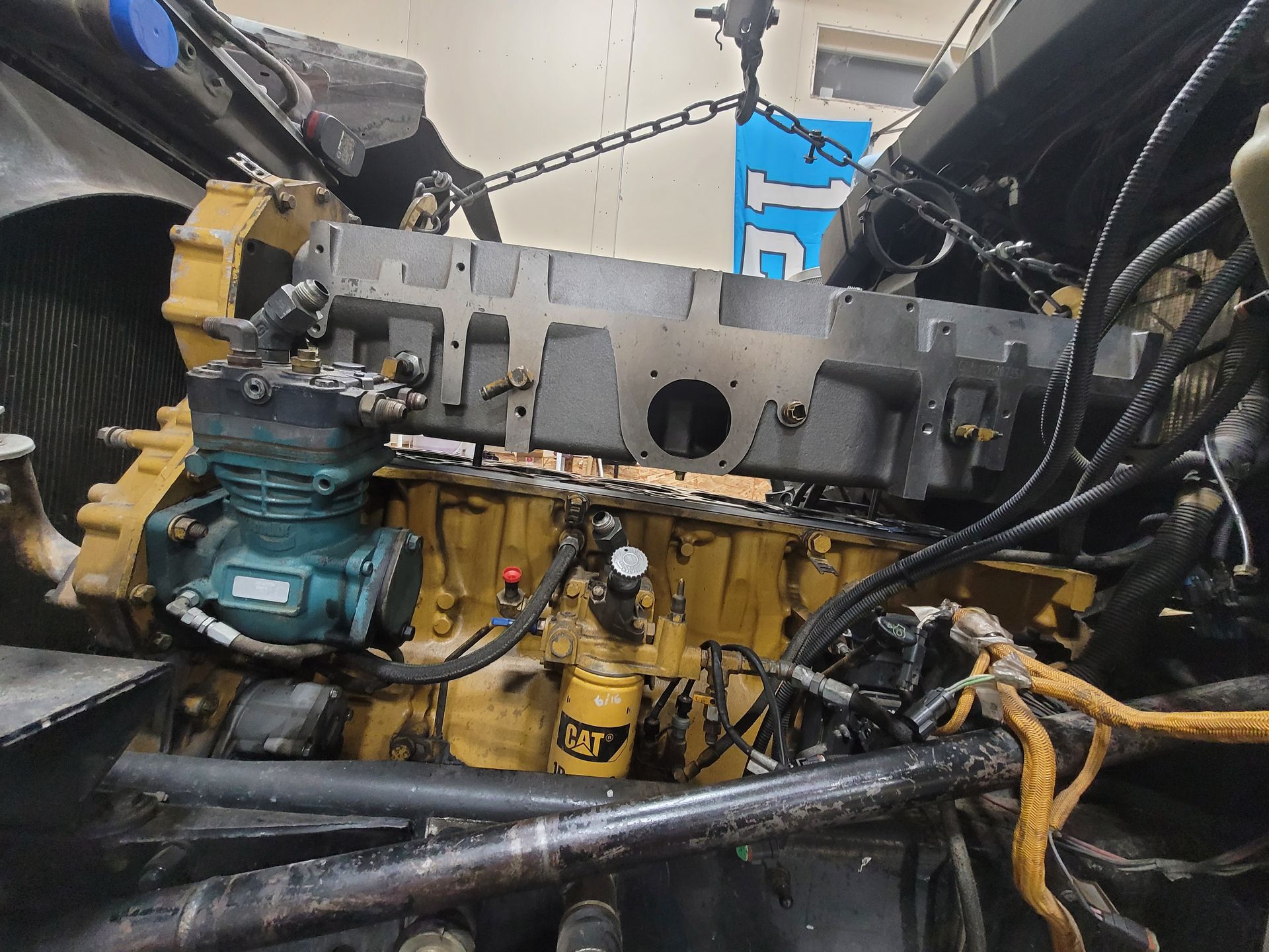 A cat engine is being worked on in a garage