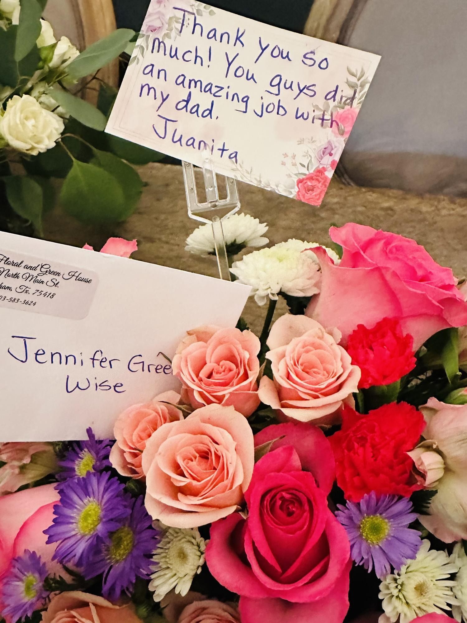 Floral arrangement with cards. One reads,