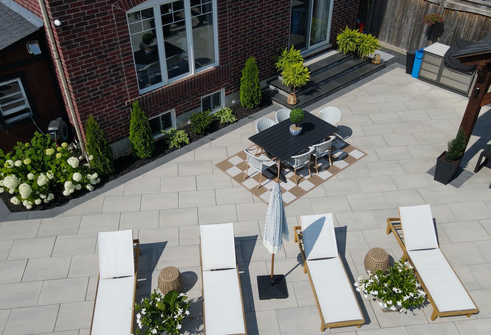 An aerial view of a patio with chairs and a table.