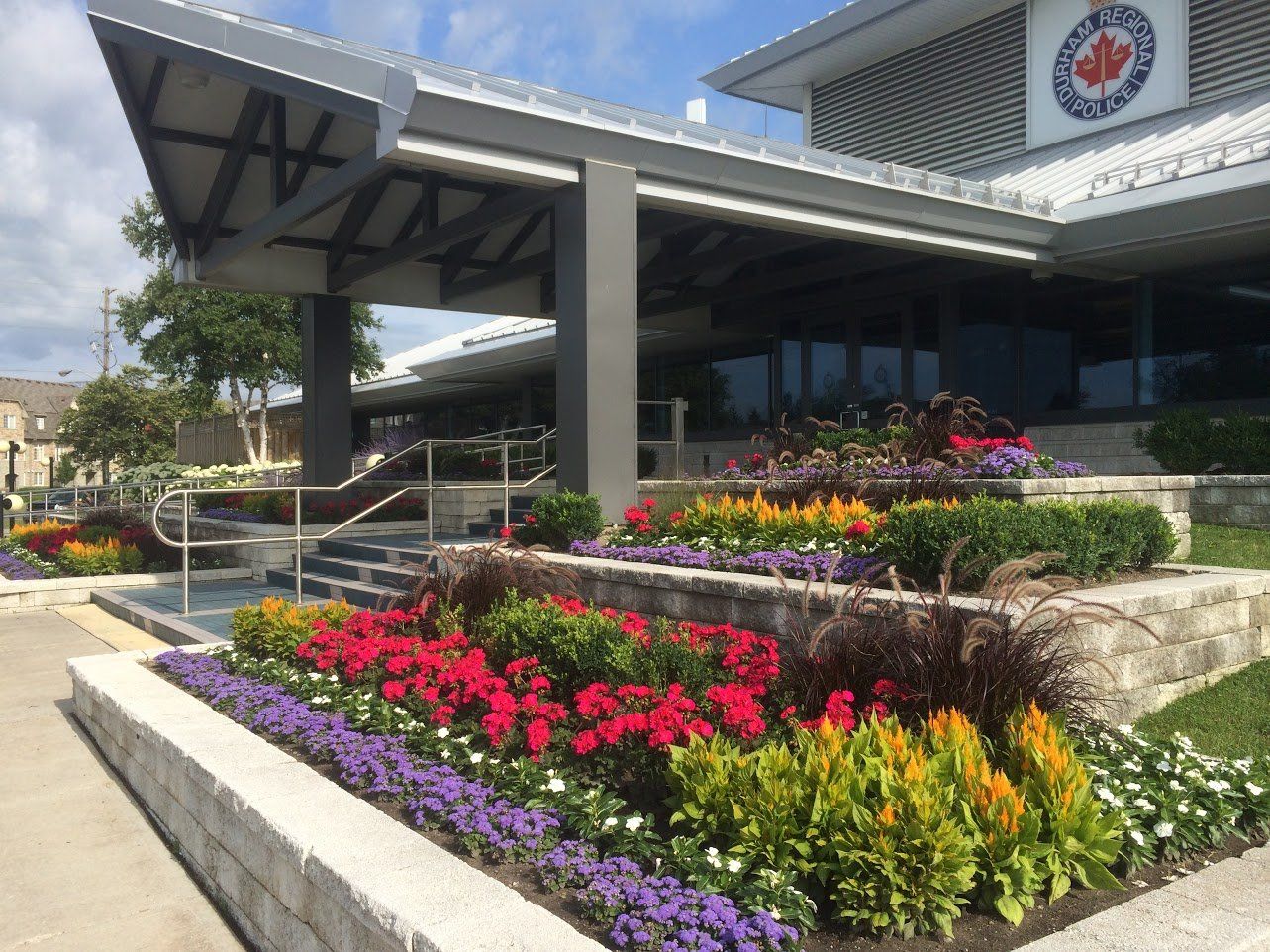 A building with a lot of flowers in front of it