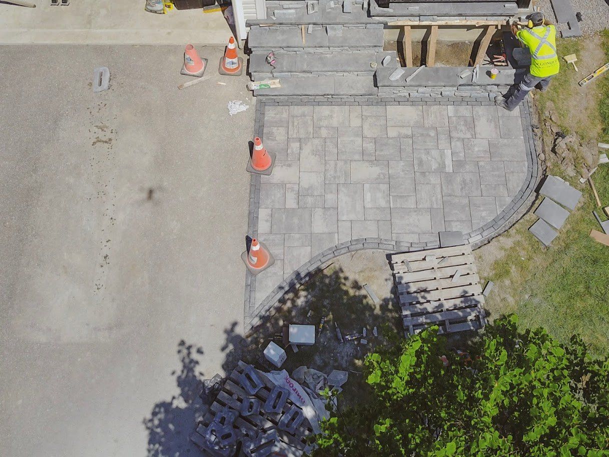 An aerial view of a construction site with a brick walkway being built.