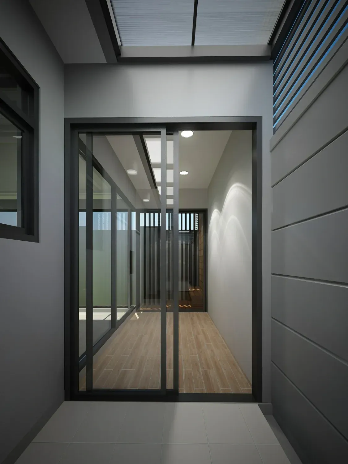 Hallway with glass sliding doors, wooden floors, and modern gray walls.