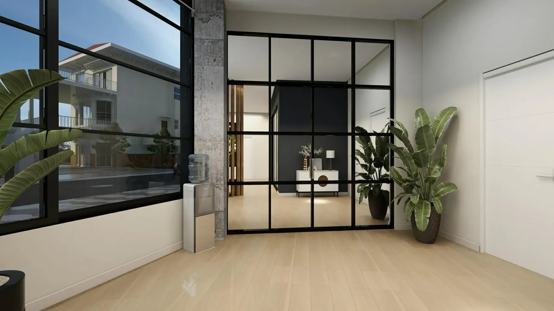 Modern interior with black framed glass wall, plants, and natural light.