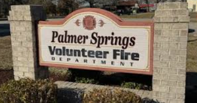 A rectangular sign with Palmer Springs Volunteer Fire Department written on it, held up by two stone pillars. A rectangular sign with Palmer Springs Volunteer Fire Department written on it, held up by two stone pillars.
