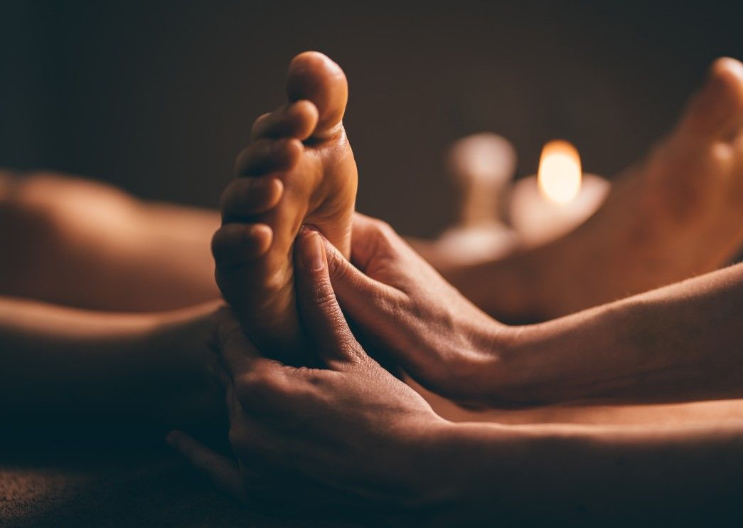 Massage Therapy Coventry continuing to massage feet after hot stones have been removed