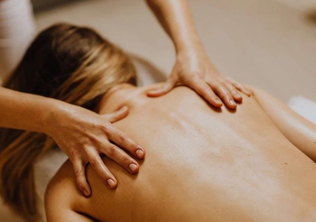Indian head massage working on the shoulders and upper back