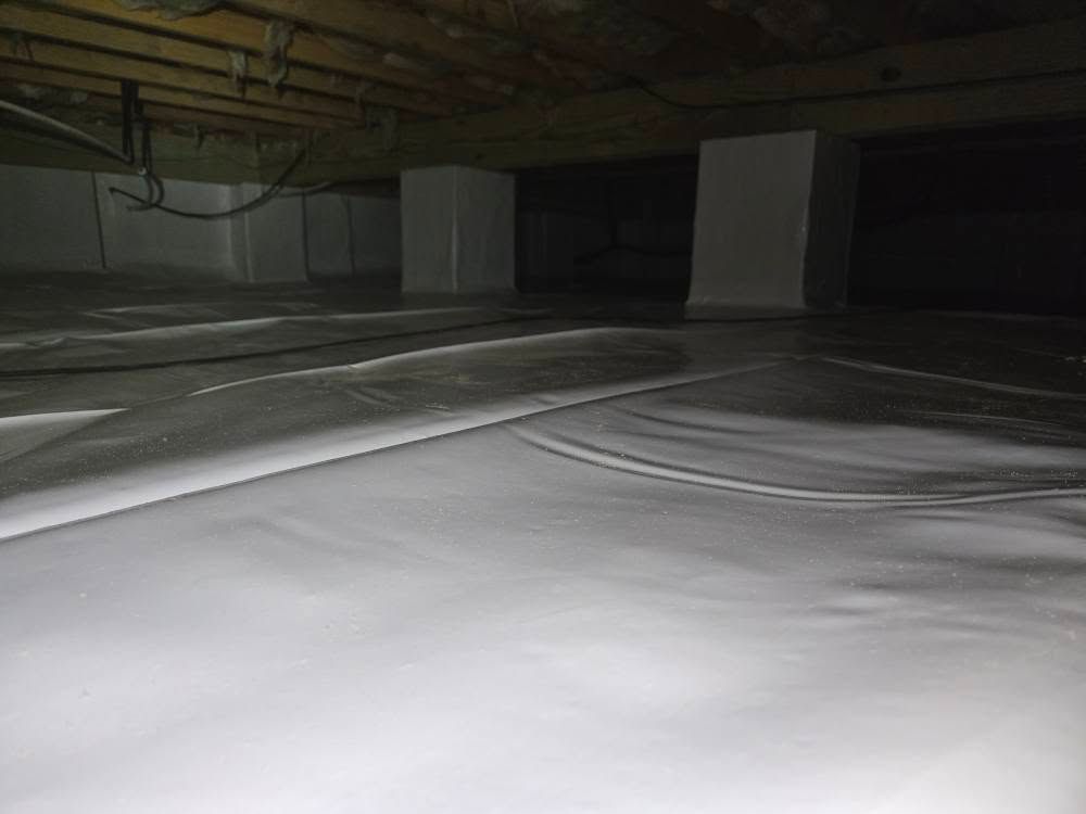 Dimly lit underground parking garage with concrete pillars and a white floor