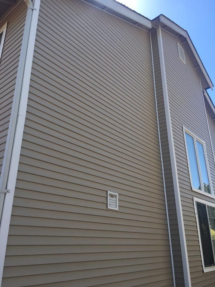 Clean house exterior wall after getting residential pressure washing service.