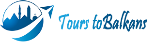 A blue and white logo for tours to balkans