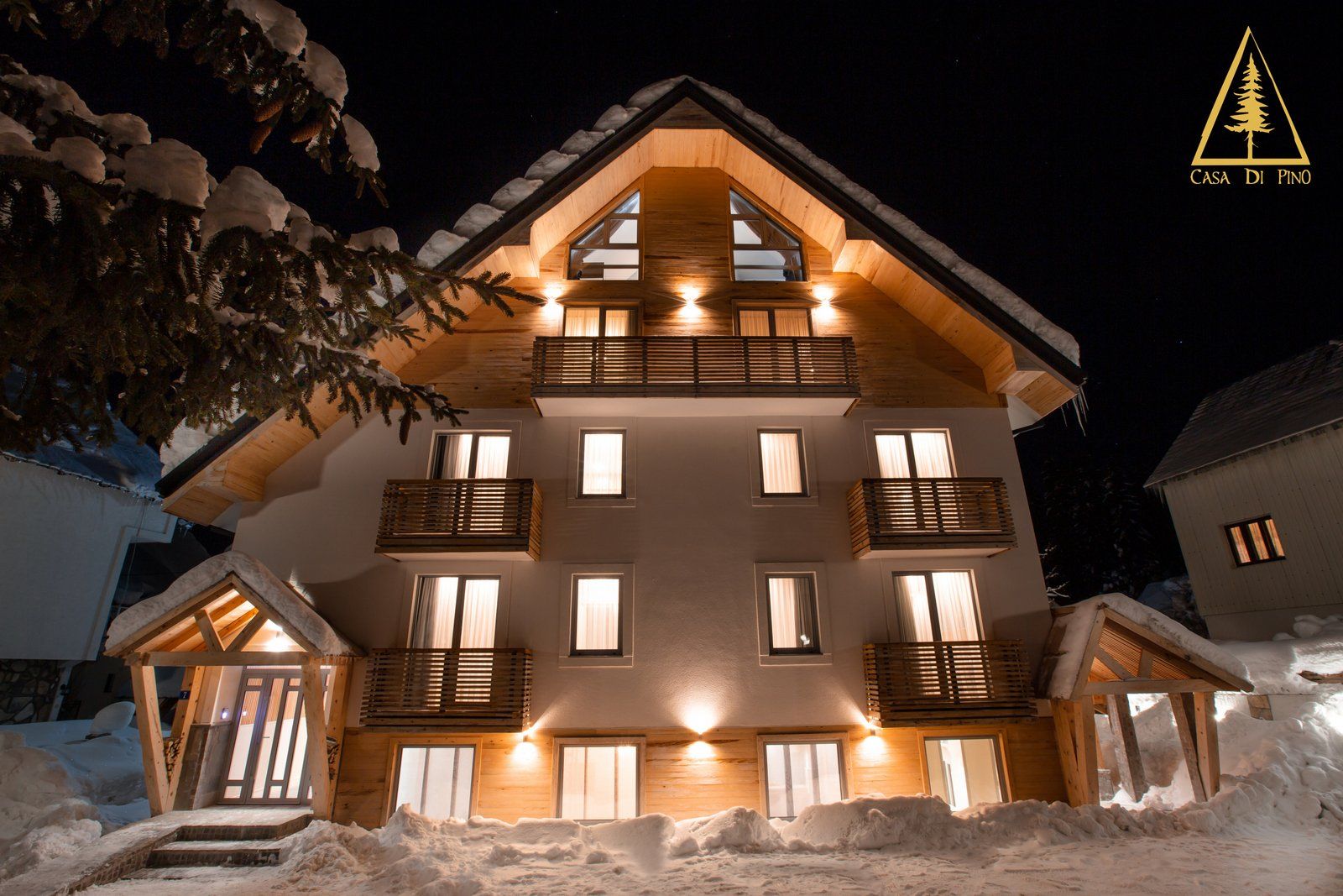 The building is lit up at night and covered in snow.