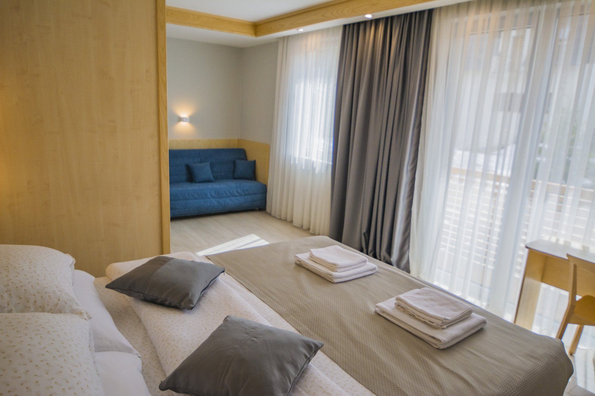 There is a bed and a couch in the hotel room. 