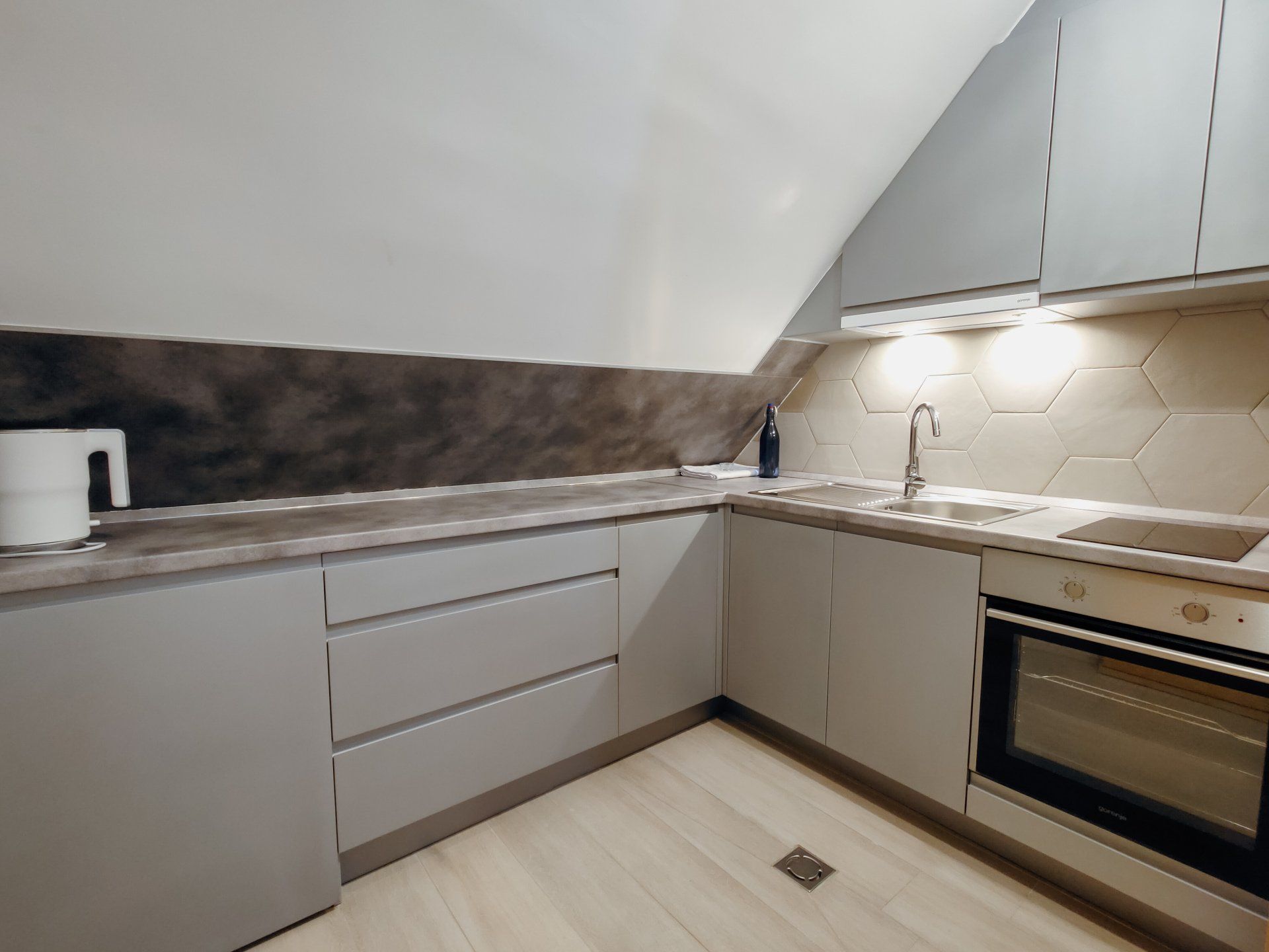 A kitchen with a sink , stove and oven