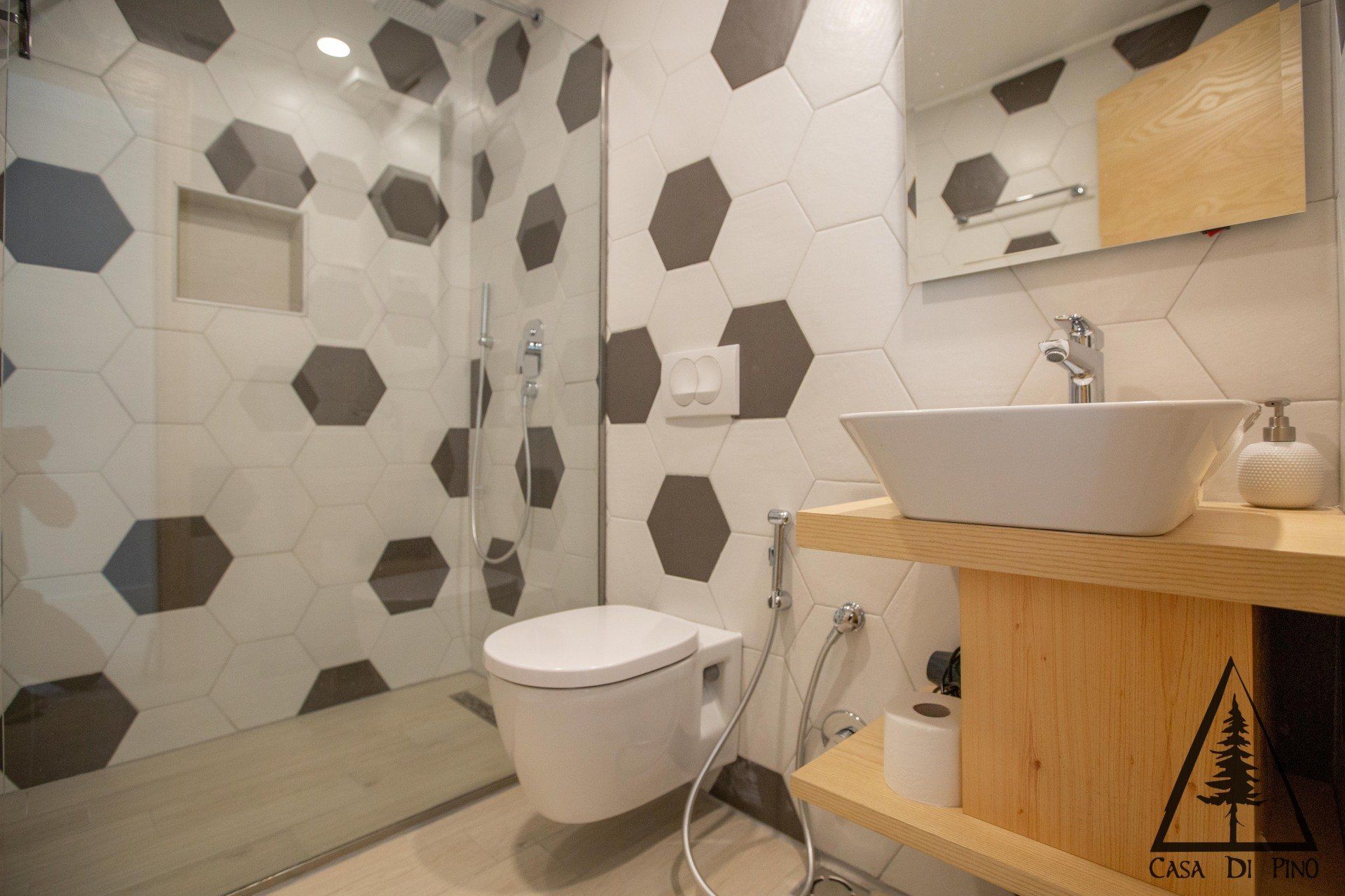 A bathroom with a toilet, sink and shower.