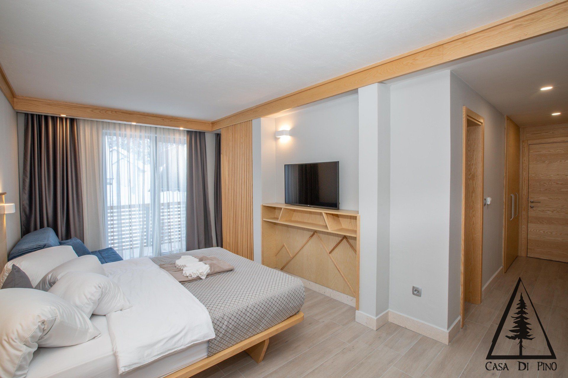 A hotel room with a large bed and a flat screen tv.