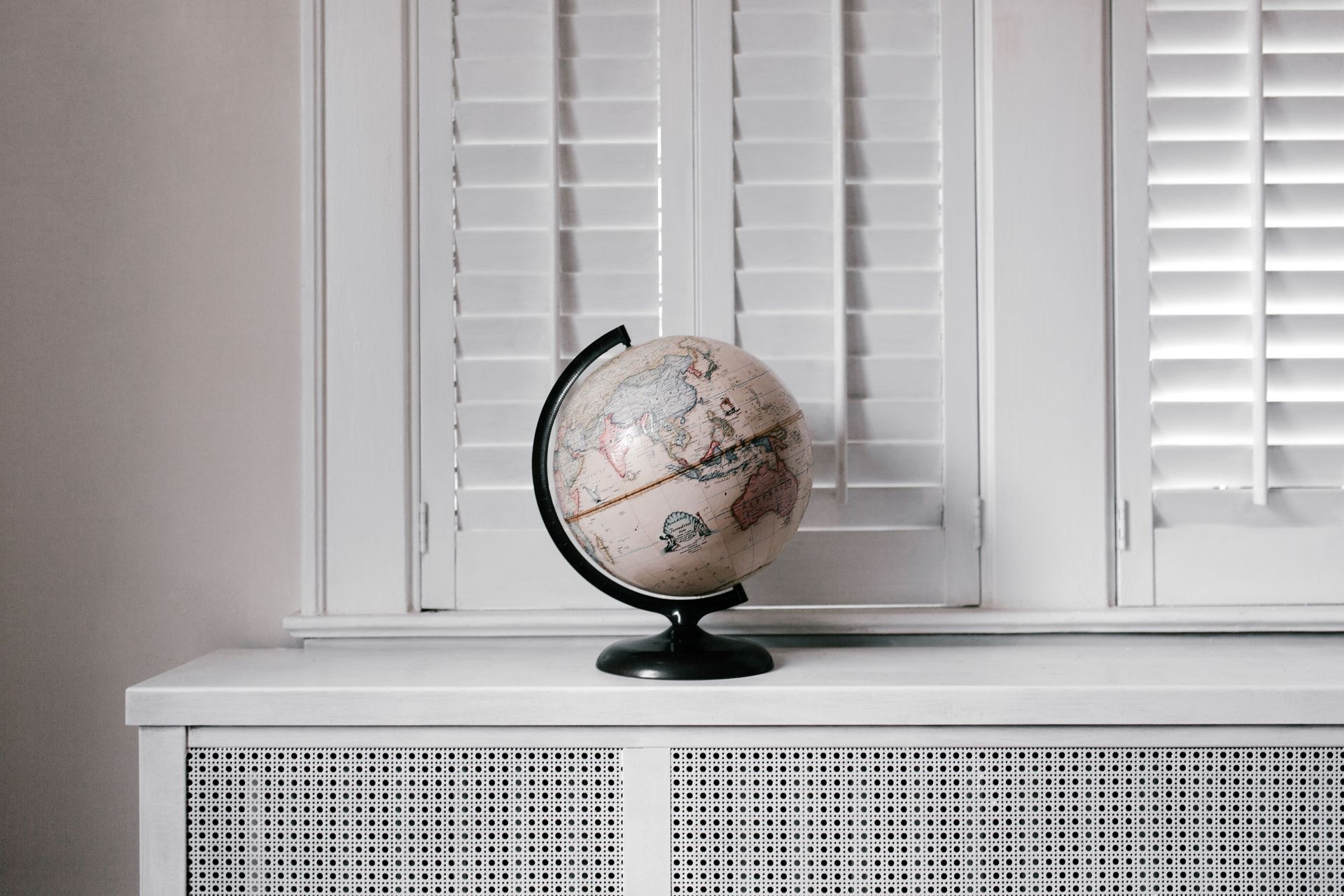 Globe Set in Front of Plantation Shutters