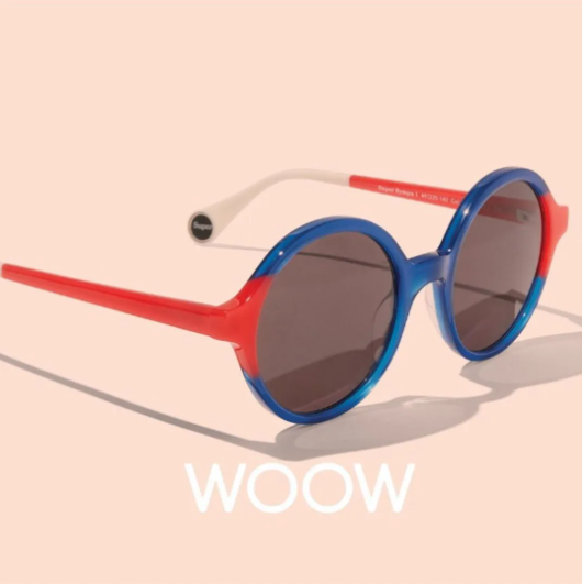 Round blue and red sunglasses on a pale pink background with the word &ldquo;WOOW&rdquo; below