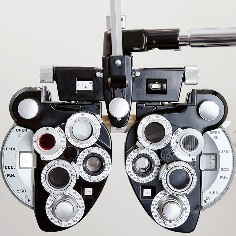 Optometrist phoropter with multiple lenses and dials for vision testing