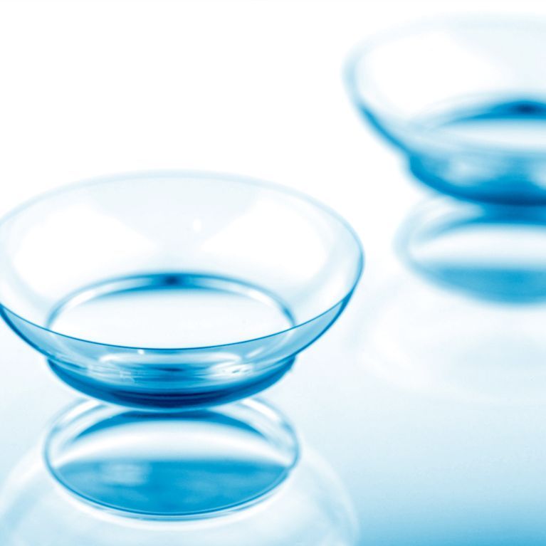 Blue glass dish on white surface with another blurred dish in the background